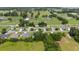 Expansive aerial view of a community with houses, paddocks, and green spaces, horse facilities and nearby homes at 7054 Sw 64Th Ter, Ocala, FL 34476