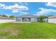 Lush backyard offers plenty of space for outdoor activities and features a covered patio at 7054 Sw 64Th Ter, Ocala, FL 34476