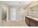 Bright bathroom featuring double sink vanity, white tiled floors and a stand-up glass shower at 7054 Sw 64Th Ter, Ocala, FL 34476