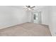 Bedroom features neutral carpet, a ceiling fan, and a window at 7054 Sw 64Th Ter, Ocala, FL 34476