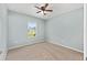 Cozy bedroom with carpeted floors, a ceiling fan, and a window at 7054 Sw 64Th Ter, Ocala, FL 34476