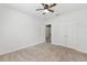 Bright bedroom with carpeted floors, double door closet, and ceiling fan at 7054 Sw 64Th Ter, Ocala, FL 34476