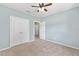 Light-blue bedroom with carpeted floors, double door closet, and ceiling fan at 7054 Sw 64Th Ter, Ocala, FL 34476