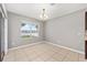 Dining area with tile floors, a window view, and hanging light fixture at 7054 Sw 64Th Ter, Ocala, FL 34476
