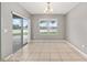 Open dining area with tile floors and sliding glass doors providing access to outdoor patio at 7054 Sw 64Th Ter, Ocala, FL 34476