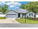 Beautiful single-story home with a well-maintained lawn, complemented by mature trees and landscaping at 7054 Sw 64Th Ter, Ocala, FL 34476