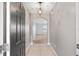 Inviting foyer featuring tile flooring, arched doorway, and a modern light fixture at 7054 Sw 64Th Ter, Ocala, FL 34476