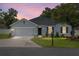 Charming one-story home featuring a two-car garage, well-manicured lawn, and landscaped front yard at 7054 Sw 64Th Ter, Ocala, FL 34476