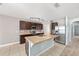Spacious kitchen with tile floor, island, track lighting, stainless steel refrigerator, and tile backsplash at 7054 Sw 64Th Ter, Ocala, FL 34476