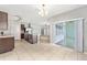 Open concept kitchen with island, stainless steel appliances, and access to both living area and outdoor patio at 7054 Sw 64Th Ter, Ocala, FL 34476