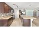 Kitchen with island, tile floors, stainless steel appliances, and breakfast bar overlooking living area at 7054 Sw 64Th Ter, Ocala, FL 34476