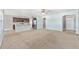 Open-concept living room featuring neutral carpet, a breakfast bar, and stainless steel appliances at 7054 Sw 64Th Ter, Ocala, FL 34476
