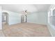 Spacious living room featuring neutral carpet, arched doorways, and views into adjacent rooms at 7054 Sw 64Th Ter, Ocala, FL 34476