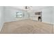 Bright living room showcasing neutral carpet, large windows, and an open floor plan at 7054 Sw 64Th Ter, Ocala, FL 34476