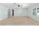 Large living room featuring neutral carpet, a ceiling fan, and ample natural light at 7054 Sw 64Th Ter, Ocala, FL 34476