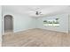 Spacious living room featuring neutral carpet, a large window, and a ceiling fan at 7054 Sw 64Th Ter, Ocala, FL 34476