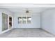 Spacious covered patio featuring a ceiling fan, offering a comfortable outdoor living space at 7054 Sw 64Th Ter, Ocala, FL 34476