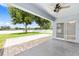 Covered patio with beautiful brickwork, ceiling fan, and views of the manicured backyard at 7054 Sw 64Th Ter, Ocala, FL 34476
