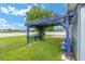 Charming backyard features a blue pergola and seating area, perfect for outdoor relaxation at 7054 Sw 64Th Ter, Ocala, FL 34476