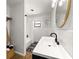 Modern bathroom with shower-tub combo, white vanity, and hardwood floors at 802 Ne 39Th Ct, Ocala, FL 34470