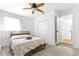 Bright bedroom with a ceiling fan, double closet, and wood-look flooring at 802 Ne 39Th Ct, Ocala, FL 34470