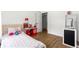Neutral bedroom featuring a play area and a white desk with a black cabinet at 802 Ne 39Th Ct, Ocala, FL 34470
