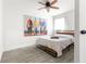 Bright bedroom features a ceiling fan, wood-look flooring, and artistic wall decor at 802 Ne 39Th Ct, Ocala, FL 34470