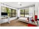 Well-lit bedroom with large windows offering a view of the surrounding trees and landscape at 802 Ne 39Th Ct, Ocala, FL 34470
