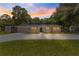 Charming single-story home with a spacious driveway and well-maintained lawn at sunset at 802 Ne 39Th Ct, Ocala, FL 34470