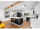 Modern kitchen features an island with a white countertop, black cabinets, and stainless steel appliances at 802 Ne 39Th Ct, Ocala, FL 34470