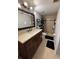 Bathroom featuring a vanity with a stone counter, neutral tile flooring, a shower with tile surround at 8134 Fairways Cir # R203, Ocala, FL 34472