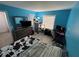 Bright bedroom with hard surface flooring, a window and blue painted walls at 8134 Fairways Cir # R203, Ocala, FL 34472