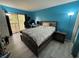 Bright bedroom with hard surface flooring, large windows and blue painted walls at 8134 Fairways Cir # R203, Ocala, FL 34472