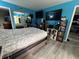 Bright bedroom with hard surface flooring, large mirrored closet doors and blue painted walls at 8134 Fairways Cir # R203, Ocala, FL 34472