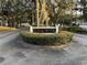 Well-kept entrance to Country Club Village with a manicured green space at 8134 Fairways Cir # R203, Ocala, FL 34472