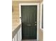 View of the front door of the condo featuring the unit number, a peephole, and white trim at 8134 Fairways Cir # R203, Ocala, FL 34472