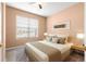 Cozy bedroom with neutral walls, plush carpet, and a large window with natural light at 8380 Sw 82Nd Cir, Ocala, FL 34481