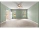 Generously sized bedroom with natural light from two windows, a ceiling fan, and convenient access to a hallway at 8380 Sw 82Nd Cir, Ocala, FL 34481