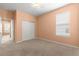 Spacious bedroom with neutral walls, carpet, a double closet, and a bright window at 8380 Sw 82Nd Cir, Ocala, FL 34481