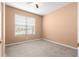 A bright bedroom features neutral walls, carpet, and natural light from the large window at 8380 Sw 82Nd Cir, Ocala, FL 34481