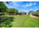 Spacious backyard with a well-kept lawn and a screened lanai, ideal for outdoor enjoyment at 8640 Sw 83Rd Loop, Ocala, FL 34481