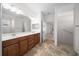 Bright bathroom featuring double sinks, granite counters and tile flooring at 8640 Sw 83Rd Loop, Ocala, FL 34481