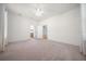 Spacious bedroom with neutral walls, plush carpeting, and access to other rooms at 8640 Sw 83Rd Loop, Ocala, FL 34481