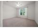Bedroom featuring a ceiling fan and large window at 8640 Sw 83Rd Loop, Ocala, FL 34481