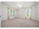 Bright bedroom with two windows, plush carpeting, and neutral walls at 8640 Sw 83Rd Loop, Ocala, FL 34481