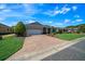 Beautiful single-story home featuring a brick-paved driveway and a well-maintained lawn at 8640 Sw 83Rd Loop, Ocala, FL 34481