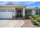 Inviting covered front entrance with brickwork and landscaping details for curb appeal at 8640 Sw 83Rd Loop, Ocala, FL 34481