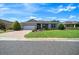 Inviting single-story home with manicured lawn, fresh landscaping, and brick paved driveway at 8640 Sw 83Rd Loop, Ocala, FL 34481