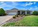 Charming single-story home featuring a well-manicured lawn and a brick-paved driveway at 8640 Sw 83Rd Loop, Ocala, FL 34481