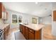 Well-lit kitchen with a large island, modern faucet, and views of the lush backyard at 8640 Sw 83Rd Loop, Ocala, FL 34481